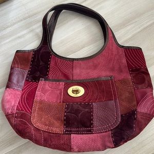 Coach tote maroons in color, suede material lined inside leather handles
